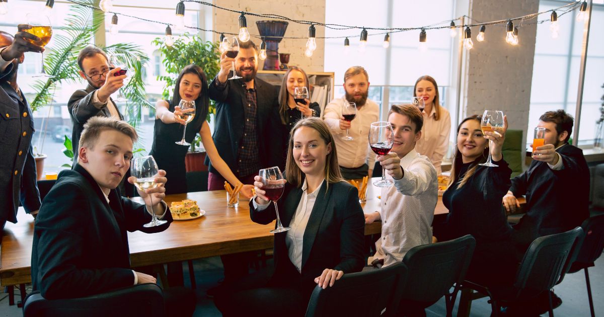 Happy people showing wine glasses at a memorable event